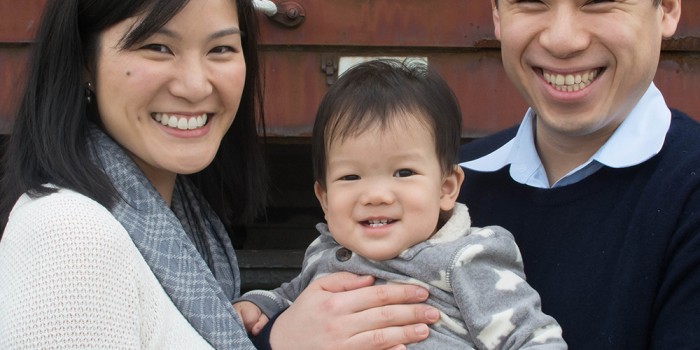 jersey city family poses in liberty state park in front of a train