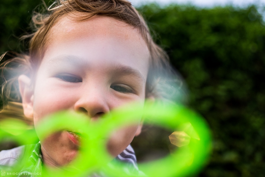 child blows bubbles