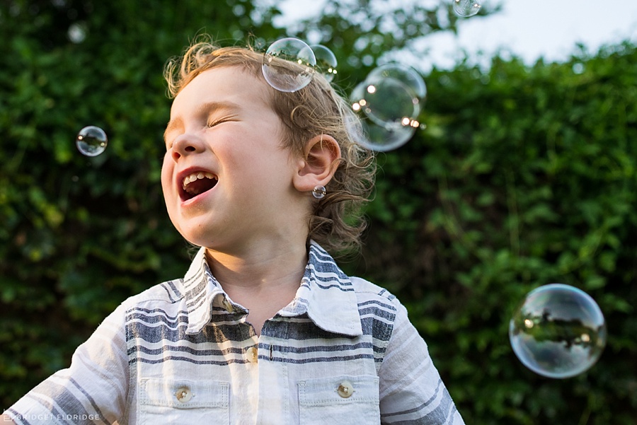 child laughs with bubbles